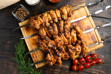 grilled or barbecue chicken wings skewer on board