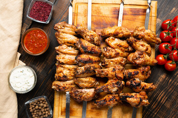 grilled or barbecue chicken wings skewer on board