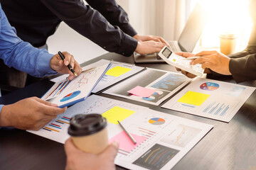 Meeting Concept Close up hands of a young businesswoman pointing to sale chart in a paper report on the table for brainstorming and discussion in meeting day, Business startup
