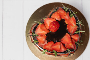 Heart shaped of delicious chocolate cake with strawberries on white background for food and bakery concept