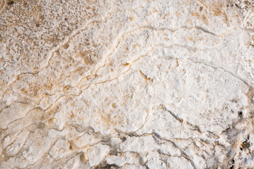 sandy beach covered with ice with traces of waves. abstract background or texture of frozen sand