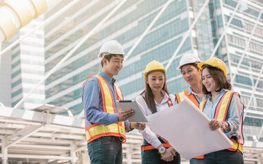 Group of engineer discussing about their construction project outside