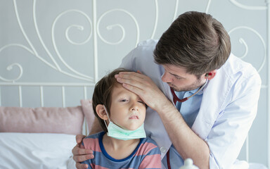 Fototapeta premium A doctor examine little boy after getting sick