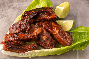 closeup of roasted pork ribs with barbecue sauce and caramelized with honey. Tasty homemade snack or small business ow
