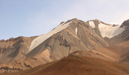 Fototapeta na wymiar Spectacular view on snow-capped mountains in Gorno-Badakshan, the Pamir region of Tajikistan. Snow covered peaks of Pamir mountains