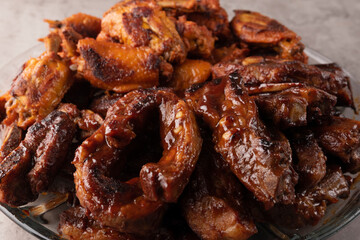 closeup of roasted pork ribs with barbecue sauce and caramelized with honey. Tasty homemade snack or small business ow