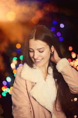 young woman laughs on a winter evening