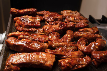 closeup of roasted pork ribs with barbecue sauce and caramelized with honey. Tasty homemade snack or small business ow