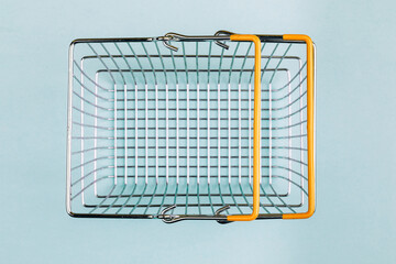 Top view of a supermarket cart on a trendy blue background. The concept of sales