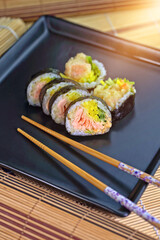 sushi roll on a black plate ready to be served