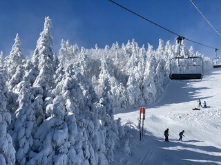 Ski chair lifts at Okemo mountain ski resort at sunny winter day in Vermont USA