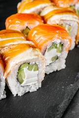 appetizing sushi roll philadelphia with eel cucumber and unagi on a black stone plate