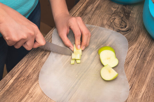 closeup of hands on latin girl cutting green apples