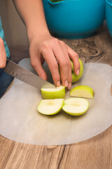 closeup of hands on latin girl cutting green apples