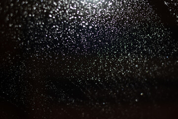 Blurred background with raindrops and lights.