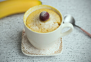 muffin in a mug with banana flavor. Muffin banana cooked in the microwave. Homemade baking. Simple cooking concept. High quality photo
