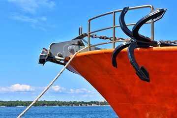 Anchor at the bow of a moored ship in the port. Anchor on a fishing boat