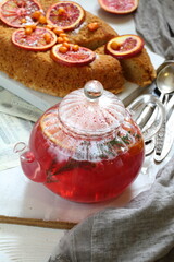 Sponge cake with red oranges on gray background