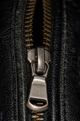 Detail of locking zipper on black leather jacket. Close up macro local focus shot. Vertical macro...