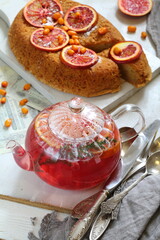 Sponge cake with red oranges on gray background