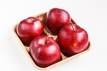 Tasty red apples on biodegradable pulp paper food tray isolated on white. Recyclable packaging concept.  Top view, flat lay, copy space