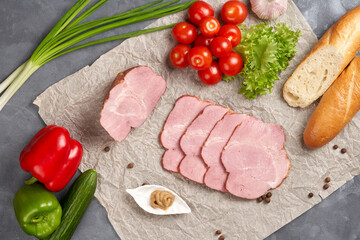 Smoked pork ham, boiled pork and sliced with tomato, onion and French baguette on paper.