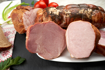 Meat delicacies. Smoked pork roll, boiled pork, brisket, pork chop with vegetables and bread