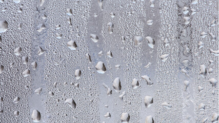 Various in shape and size frozen water drops on the glass. Texture. Macro.