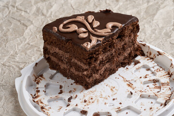 A piece of cake remaining on the packaging container.