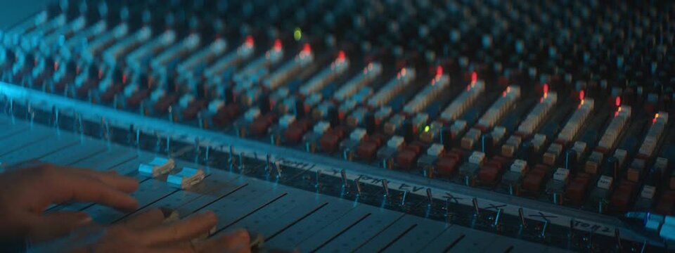 man moving knobs during a soundcheck 