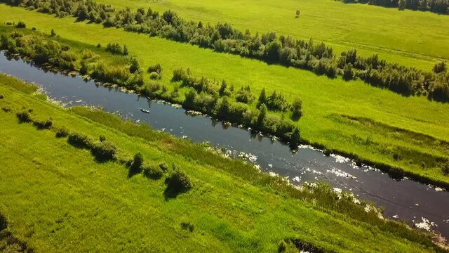 Aerial view of the Weerribben National Park, Overijssel, The Netherlands.
Dolly shot across a canal with electric boats and canoes.
