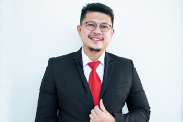 Handsome young business man wear glasses red tie in a suit and west.