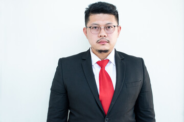 Handsome young business man wear glasses red tie in a suit and west.