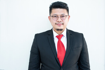 Handsome young business man wear glasses red tie in a suit and west.