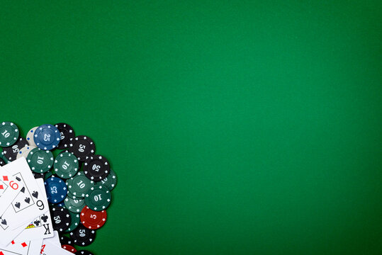 Cards and poker chips on a green background