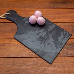 Black stone board with easter eggs with space for text