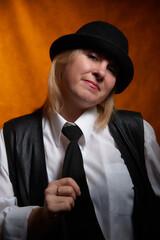 Portrait of fat plump chubby middle-aged woman with hat. Model posing in male style in the Studio.