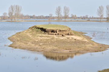 A secluded island in the river with a flat grassy top