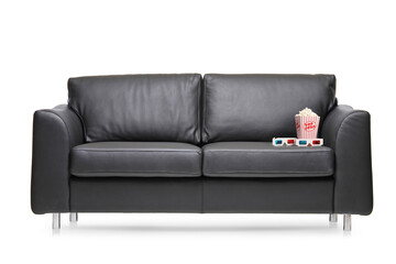 Black leather sofa with a box of popcorn and 3D glasses