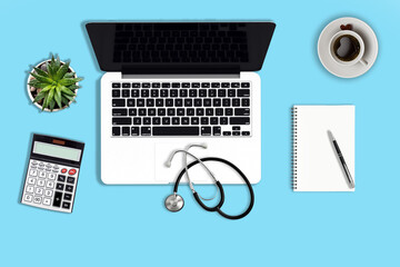 Mockup image of modern white office desk with laptop computer with blank screen, medical stethoscope, calculator, empty diary notebook, pen and cup of coffee. Top view. Flat lay