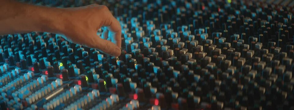 man moving knobs during a soundcheck 