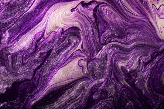 Abstract violet shimmer background.Make up concept.Beautiful stains of liquid nail laquers.Fluid art,pour painting technique.Good as digital decor,copy space.Horizontal photography.