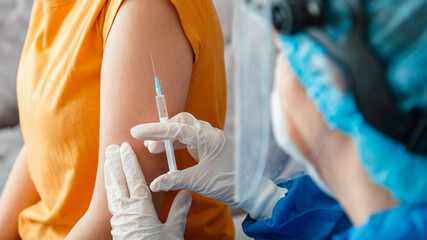 Coronavirus covid 19 vaccine Injection. Nurse do vaccination to woman in hand. Injection with...