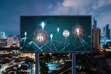 World planet Earth map hologram and social media icons on billboard over night panoramic city view of Kuala Lumpur, Malaysia, Asia. Networking and establishing new connections between people. Globe