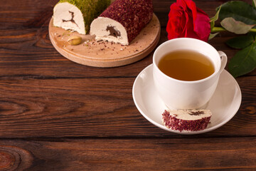 Cup with tea t oriental sweet chocolate halva with pistachios and pink powder