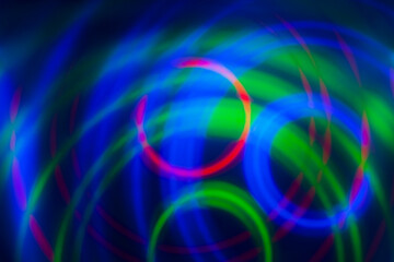 abstract background, colored circles on a black background, circles in motion