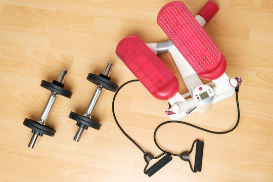 Dumbbells and twister stepper on the floor at home. Keeping fit during lockdown. Fitness equipment for strength training 