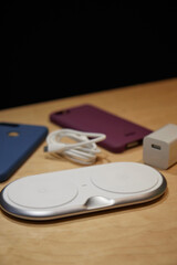 stylish wireless charger for smartphone on the table background is blurred