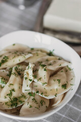 Dumplings, filled with potatoes and served with butter and fennel. Varenyky, vareniki, pierogi, pyrohy. Dumplings with filling.