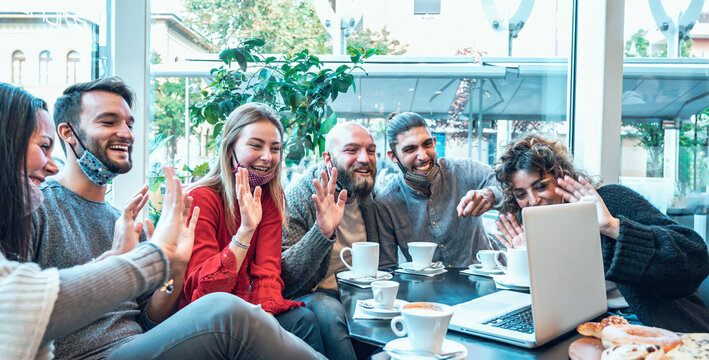 Multiracial young creative people smart working at bar wearing protective face mask - Group of young business people are working together with laptop, tablet, smart phone, notebook